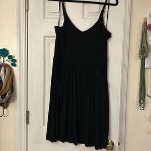 Black spaghetti strap swing dress with adjustable straps and pockets